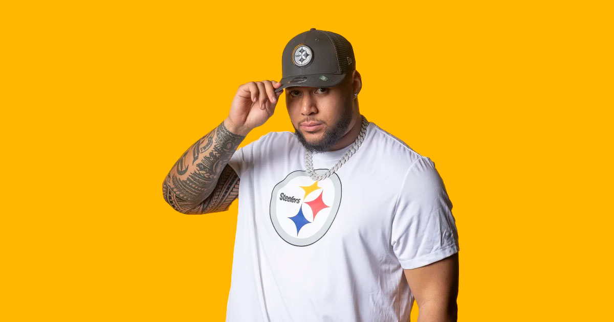 Pittsburgh Steelers First Round Pick, OL, Troy Fautanu holding a Terrible Towel.